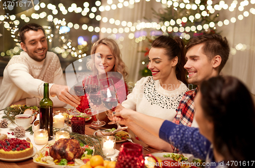 Image of friends celebrating christmas and drinking wine