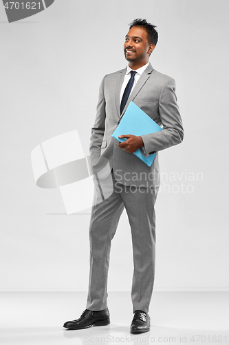 Image of indian businessman with folder over grey