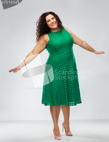 Image of happy woman in green dress over posing