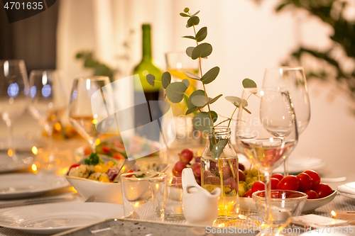 Image of table served with plates, wine glasses and food