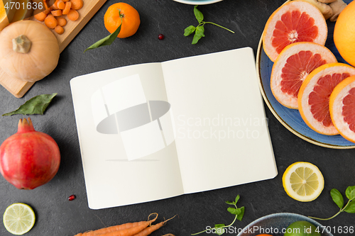 Image of close up of notebook, fruits and vegetables