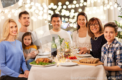 Image of happy family having dinner party at home