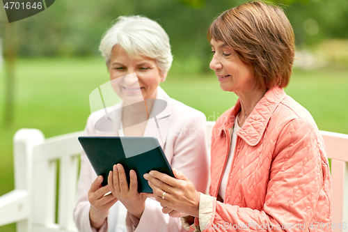 Image of senior women with tablet pc at summer park