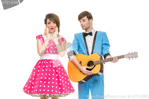 Image of doll looking boy and girl with guitar