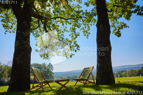Image of Relax with wooden chair and table. Enjoy the view of garden forest