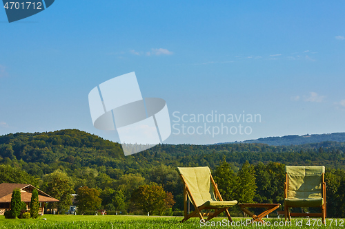 Image of Relax with wooden chair and table. Enjoy the view of garden forest