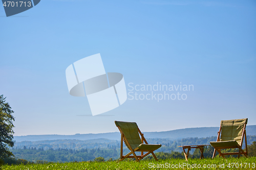 Image of Relax with wooden chair and table. Enjoy the view of garden forest