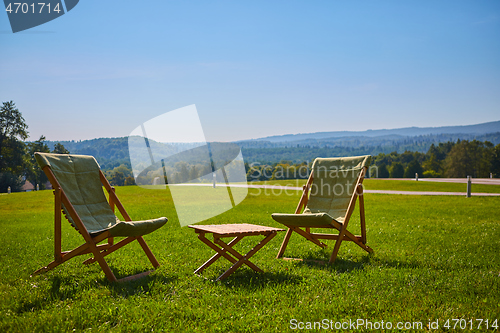 Image of Relax with wooden chair and table. Enjoy the view of garden forest