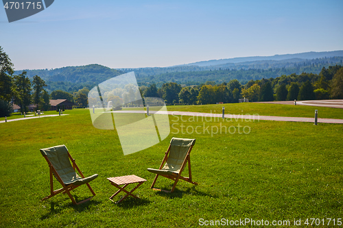 Image of Relax with wooden chair and table. Enjoy the view of garden forest