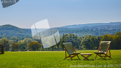 Image of Relax with wooden chair and table. Enjoy the view of garden forest