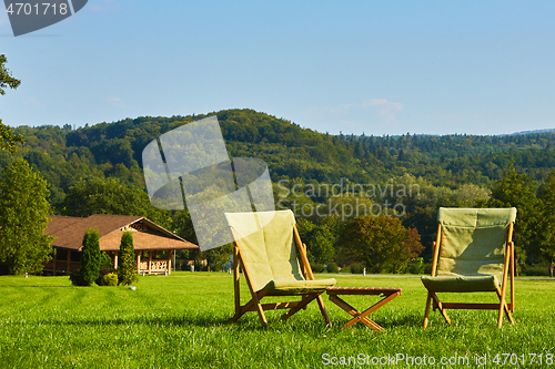 Image of Relax with wooden chair and table. Enjoy the view of garden forest