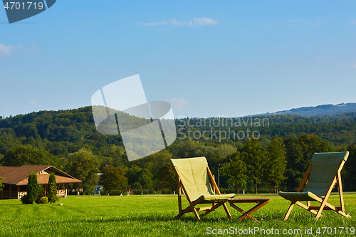 Image of Relax with wooden chair and table. Enjoy the view of garden forest