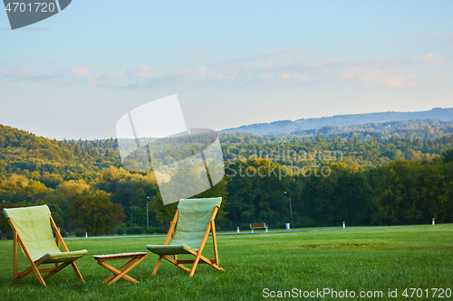 Image of Relax with wooden chair and table. Enjoy the view of garden forest