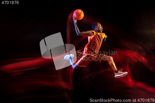 Image of Young basketball player against dark background