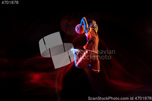 Image of Young basketball player against dark background