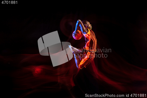 Image of Young basketball player against dark background