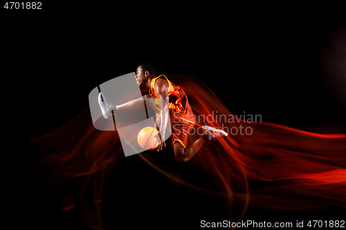 Image of Young basketball player against dark background