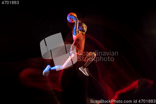 Image of Young basketball player against dark background