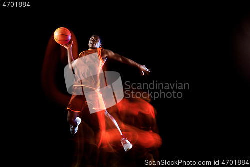 Image of Young basketball player against dark background