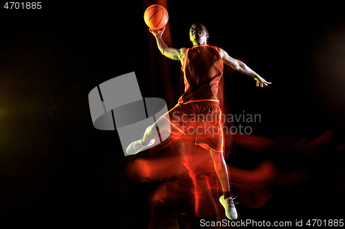 Image of Young basketball player against dark background