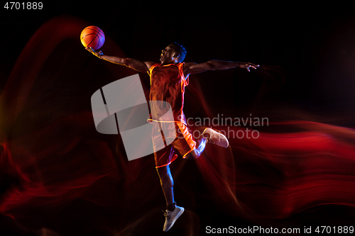 Image of Young basketball player against dark background