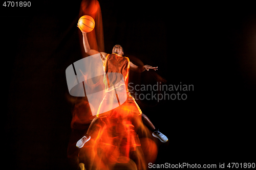 Image of Young basketball player against dark background