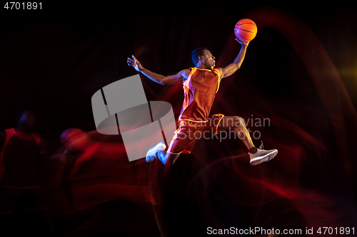 Image of Young basketball player against dark background