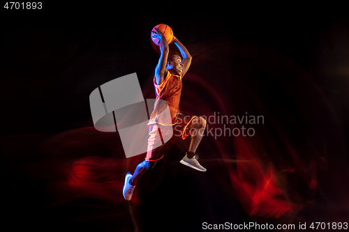 Image of Young basketball player against dark background
