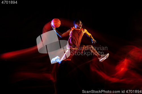 Image of Young basketball player against dark background