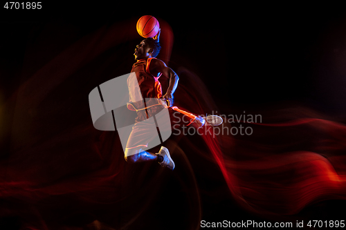 Image of Young basketball player against dark background