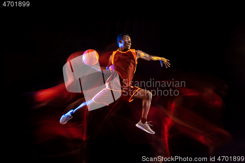 Image of Young basketball player against dark background