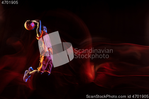 Image of Young basketball player against dark background