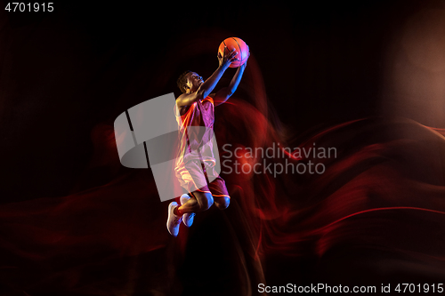 Image of Young basketball player against dark background