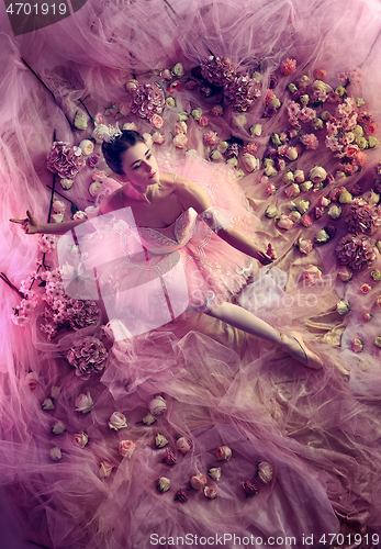 Image of Young woman in pink ballet tutu surrounded by flowers