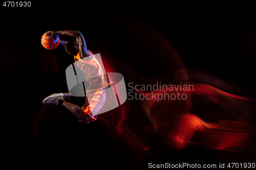 Image of Young basketball player against dark background