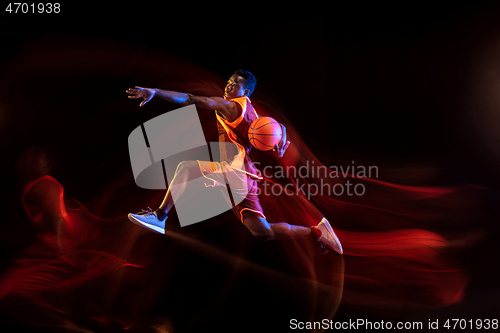 Image of Young basketball player against dark background