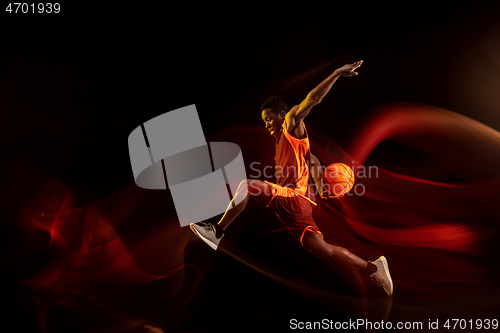 Image of Young basketball player against dark background