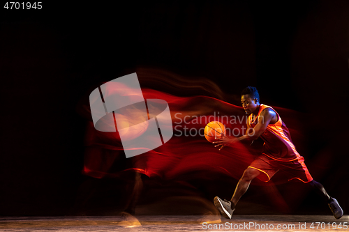 Image of Young basketball player against dark background