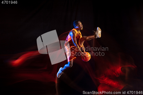 Image of Young basketball player against dark background