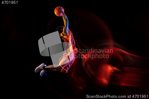 Image of Young basketball player against dark background