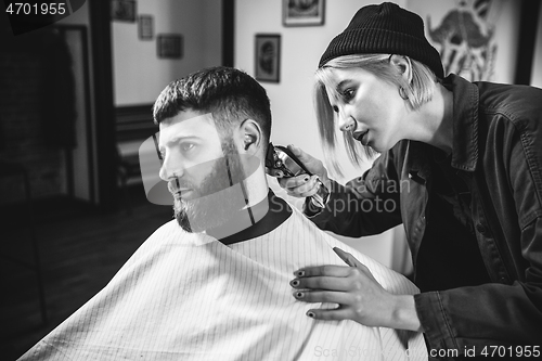 Image of Client during beard shaving in barber shop