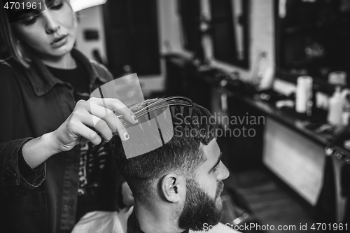 Image of Client during beard shaving in barber shop