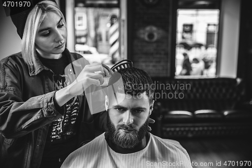 Image of Client during beard shaving in barber shop