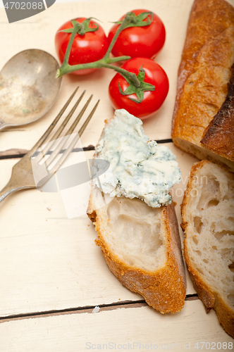 Image of fresh blue cheese spread ove french baguette