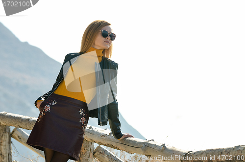 Image of Girl tourist enjoying the view from the mountain