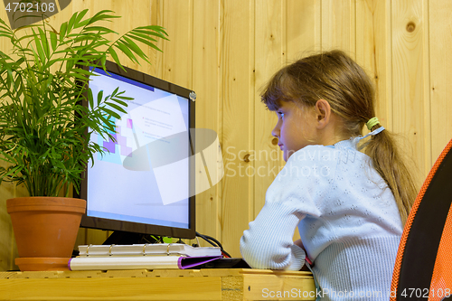 Image of A girl solves a problem on a computer during distance learning