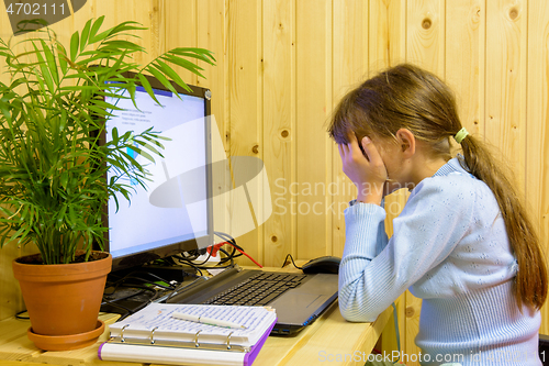 Image of The girl closed her eyes from the fatigue of distance learning