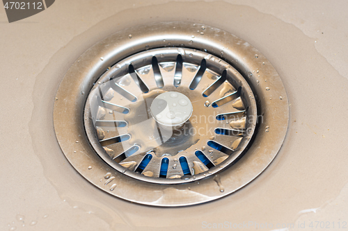 Image of Drain in the sink with a mesh lid close-up