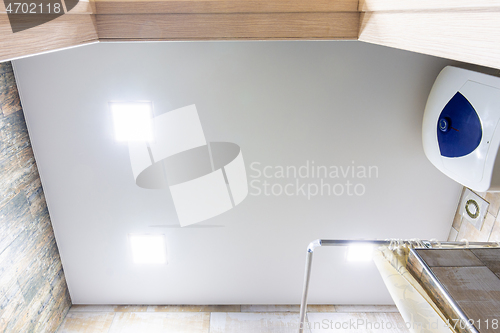 Image of Stretch matte ceiling in the bathroom with three square lamps