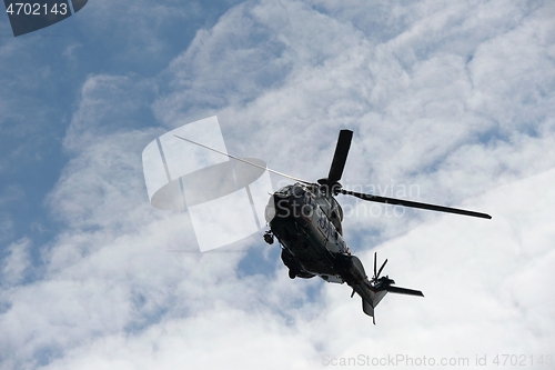 Image of flying helicopter against the sky